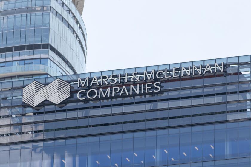 Marsh & Mclennan Companies logo atop of their building in downtown Toronto.