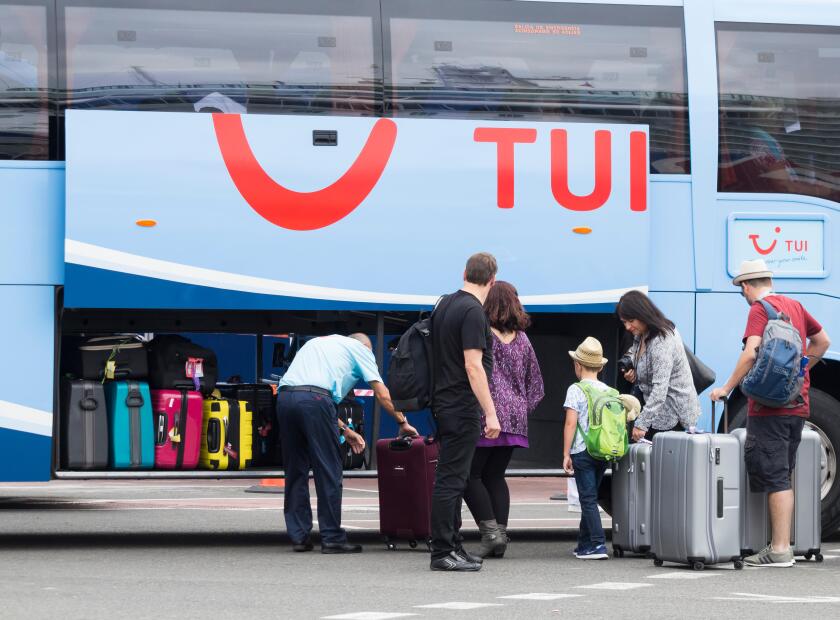Tui coach driver loading luggage at airport in Spain