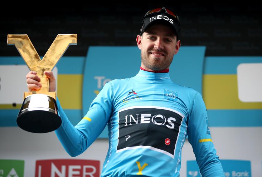Team Ineos' Chris Lawless celebrates winning the Tour de Yorkshire with the trophy.