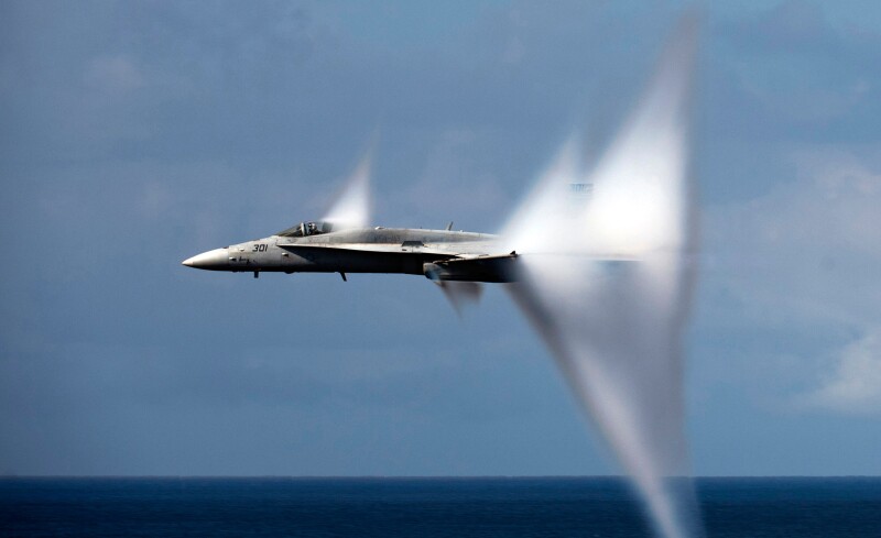 F/A-18C Hornet Jet airplane breaking the sound barrier.