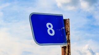 Kilometer blue sign on a pole with the number eight