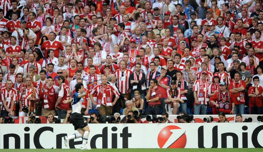 Inter Milan forward Diego Milito celebrates scoring as he runs past Bayern Munich fans during the Champions League final soccer match between Bayern Munich and Inter Milan at the Santiago Bernabeu stadium in Madrid, Saturday May 22, 2010. (AP Photo/Daniel