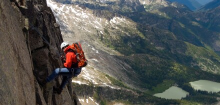 Male alpine rock climber steep cliff Kane Peak