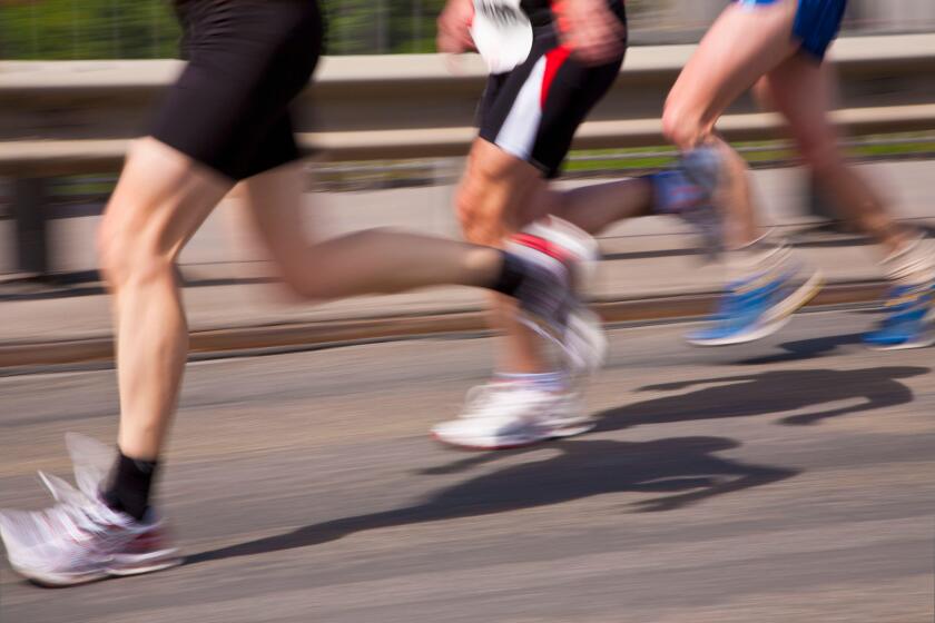 Germany, Baden-Wurttemberg, Stuttgart, Three runners in motion during half marathon
