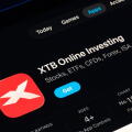 XTB Online Investing listing captured on iPad, Apple Liquid Glass look in iOS 26 highlights refreshed UI and typography. Stafford, United Kingdom, Sep
