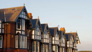 A row of large Edwardian style house rooftops in early morning sun at Scarborough