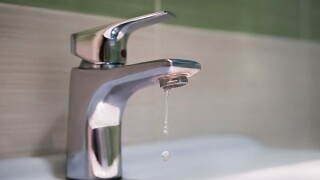 Traditional silver tap dripping. Broken faucet in the tub dripping water. Leaking plumbing. Wasteful water consumption. the concept of saving water.