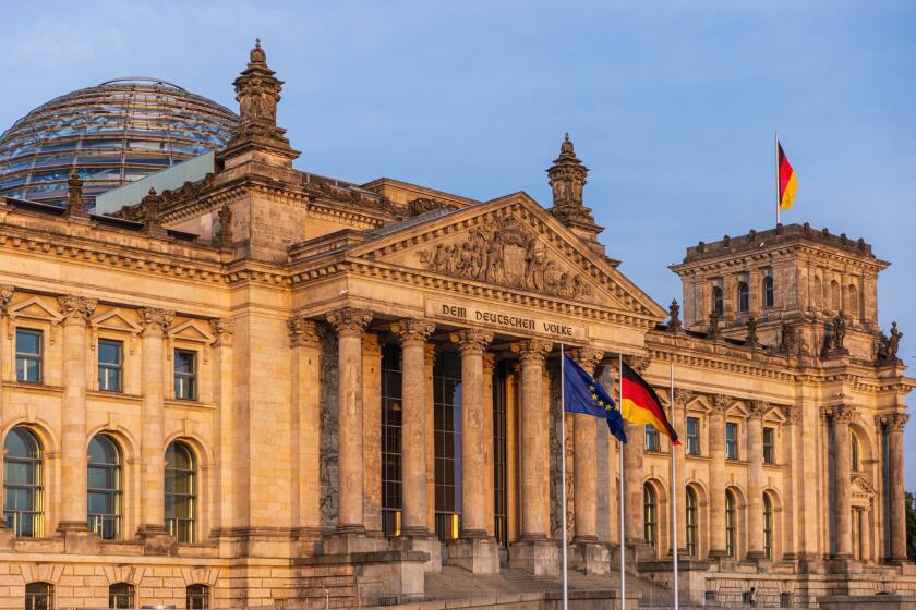 German Parliament the Bundestag in the Reichstag Building. Text says: To the German Population German Parliament the Bundestag in the Reichstag Buildi