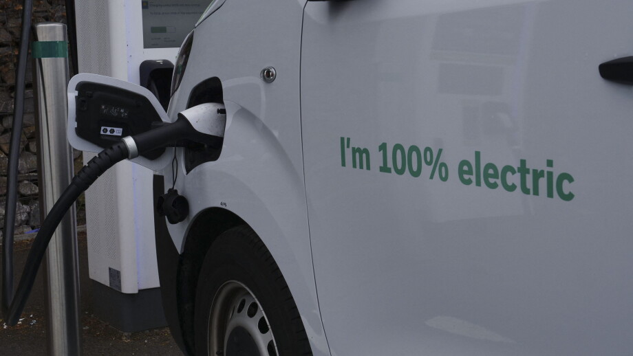 An electric van charges at a Moto service station on the M5 motorway, Exeter, UK