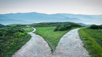 landscape of a fork in the road at storm weather, concept of insecurity of future