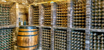 Traditional wine cellar featuring brick vaulted ceilings and stone flooring at Kingston Lacy country house, Kingston Lacy, Dorset, England, UK
