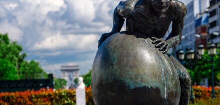 Paris, France. Hans Marks's "Sisyphe" (Sisyphus) on Avenue Charles de Gaulle. The arch of triumph can be seen in the background.
