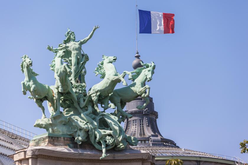 French flag and sculpture on top of  Grand Palais in Paris, France