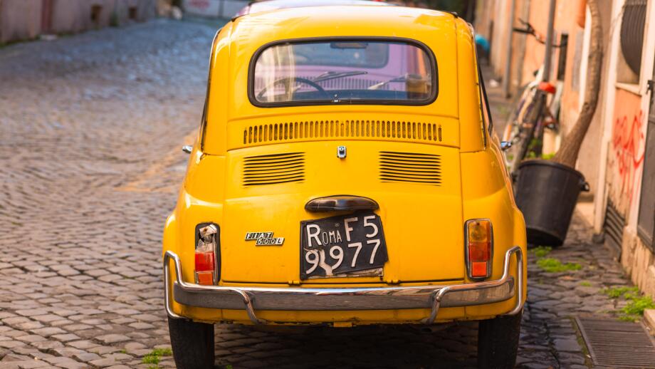 Two classic Fiat 500 cars parked on Trastevere backstreet, Rome, Lazio, Italy.