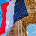 Arc de Triomphe and French flag, Paris, France. Completed in 1836 monument to the dead in the French Revolution and Napoleonic Wars. Includes Tomb to