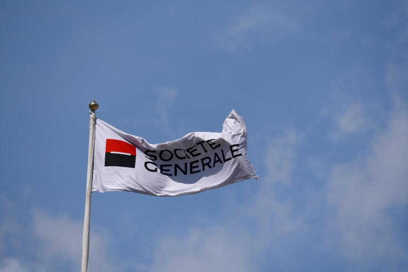 Societe Generale flag flying above the banking business building in Tower Hill, London. Space for copy. Blue sky