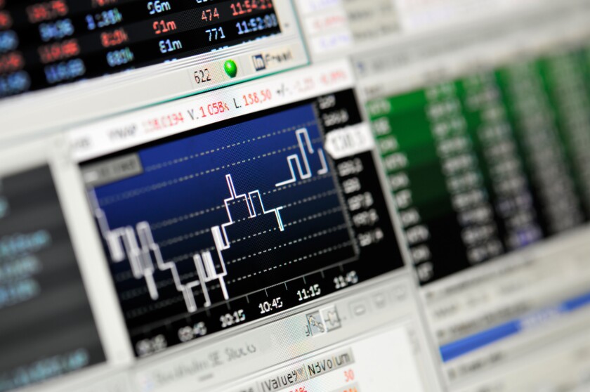 Close-up of stock market values on LCD screen.
