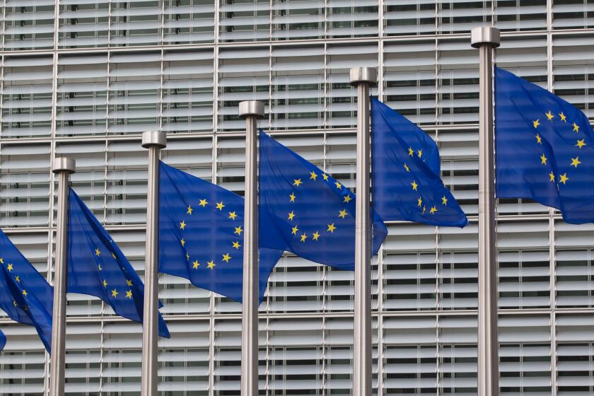 European flags in front of the Berlaymont building, headquarters of the European commission in Brussels, Belgium