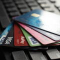 Selective focus on a group of credit and debit cards placed on a computer keyboard