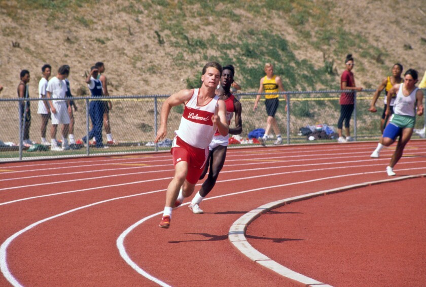 High school athletes take the curve of the track during race at track meet. Image shot 2004. Exact date unknown.