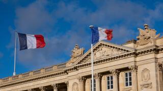 French flags in front of building in Paris, France