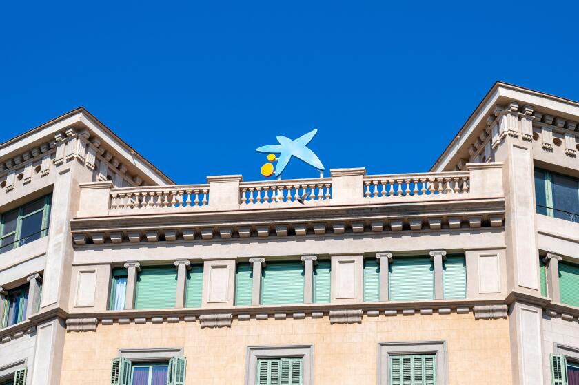 Logo or sign of Caixa Bank on top of an old building