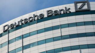 A logo sign outside of an office building occupied by Deutsche Bank in Amsterdam, Netherlands on October 4, 2015.