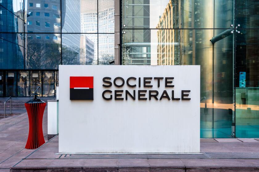 Sign of the Societe Generale at the entrance of the head office of the french banking group in La Defense business district.