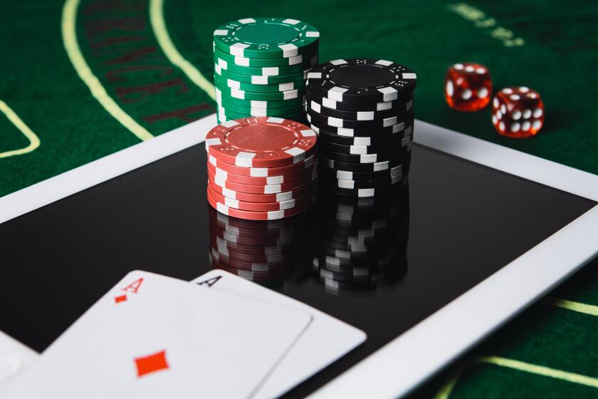 Online poker gambling concept. Chips and poker card on a digital tablet