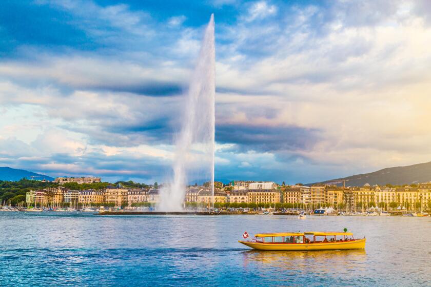 Classic view of Geneva skyline with famous Jet d'Eau fountain at Lake Geneva in beautiful evening light at sunset, Switzerland