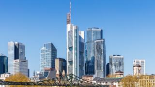 Frankfurt skyline skyscrapers with banks on River Main with bridge excursion boats in Frankfurt, Germany