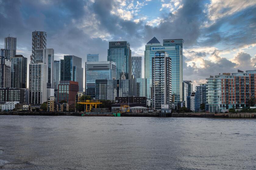 Modern skyscrapers of Canary Wharf viewed from the Thames River. London, UK, 14 October 2023