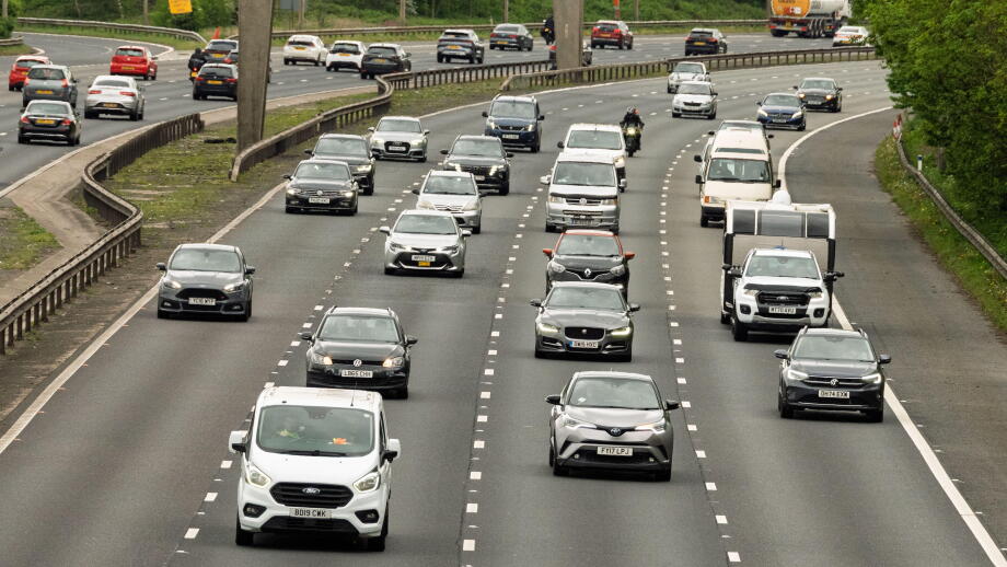 Cars and trucks travel along the M6 north in Warrington during a bustling afternoon, showcasing the rhythm of everyday life on this major highway.
