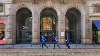 Milan, Italy. 24th Dec, 2023. A group of joggers run past the offices of the BPER bank (Banca Popolare dell'Emilia Romagna) in Milan, Italy on 24 December 2023. Photo by Laurent Coust/ABACAPRESS.COM Credit: Abaca Press/Alamy Live News