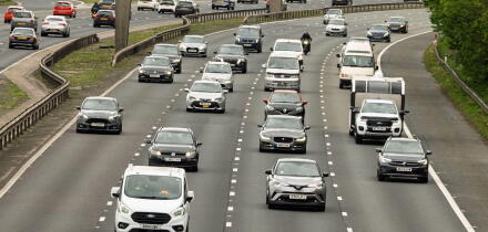 Cars and trucks travel along the M6 north in Warrington during a bustling afternoon, showcasing the rhythm of everyday life on this major highway.