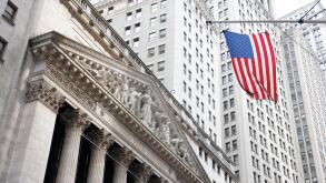 New York, United States. 22nd July, 2024. An American flag hangs near the entrance to the New York Stock Exchange (NYSE) on Wall Street in New York City on Monday, July 22, 2024. Markets were up slightly at the open after President Joe Biden's surprise an