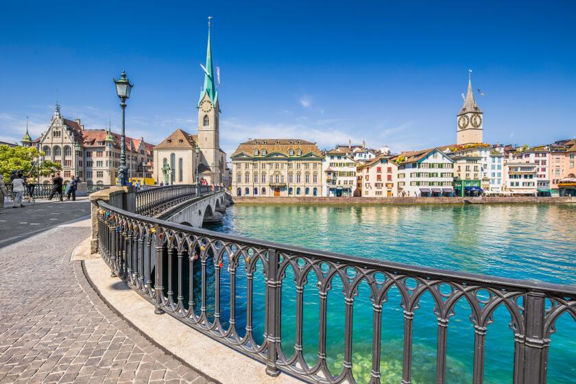 Historic city center of Zurich with famous Fraumunster Church and Munsterbucke crossing river Limmat, Canton of Zurich, Switzerland