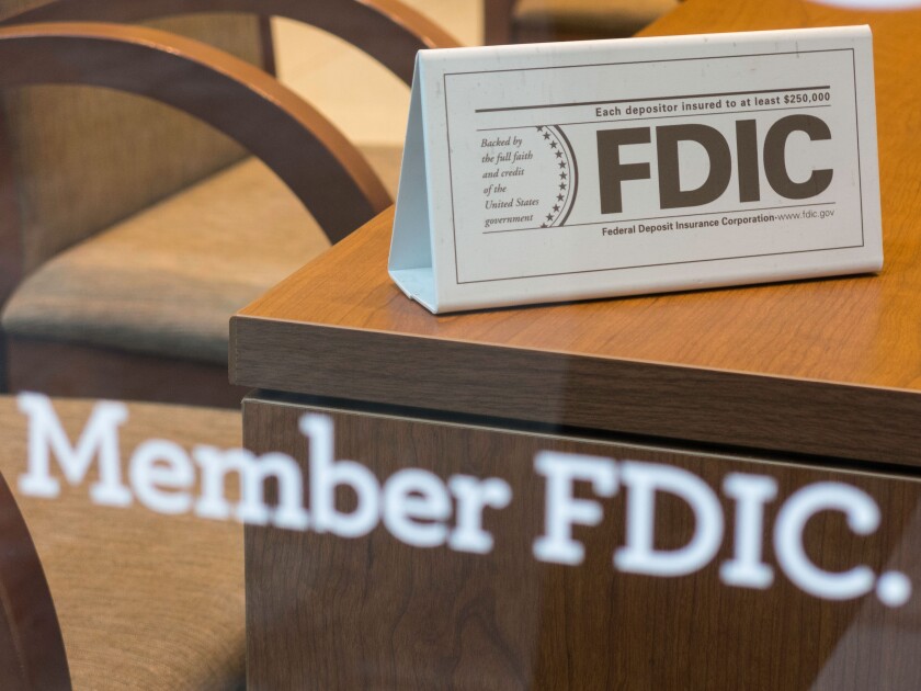 Bank Member FDIC Sign on Window and Desk, USA. Image shot 2013. Exact date unknown.