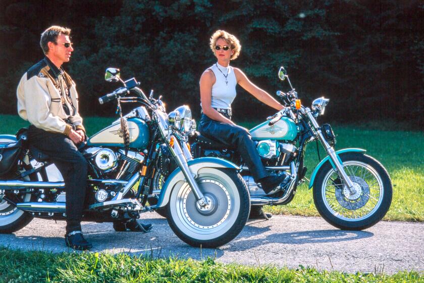 Couple by Harley Davidson motorcycles