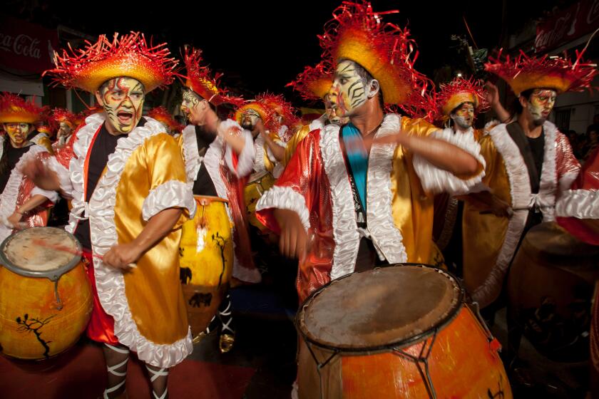 Traditional Murgas and samba schools during the Llamadas procession that starts the carnival in Montevideo, Uruguay