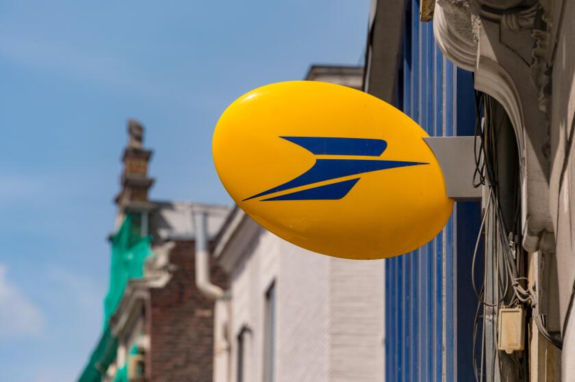 Lille, France - 15 June 2018: Logo of La Poste, French national postal service on Rue Nationale.