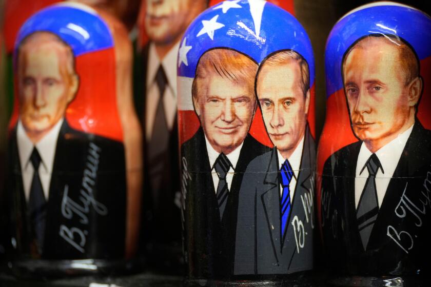 Traditional Russian wooden dolls, called Matryoshka, depicting Republican presidential nominee an former US President Donald Trump, center left, and Russian President Vladimir Putin are displayed for sale at a souvenir shop in St. Petersburg, Russia, Tues