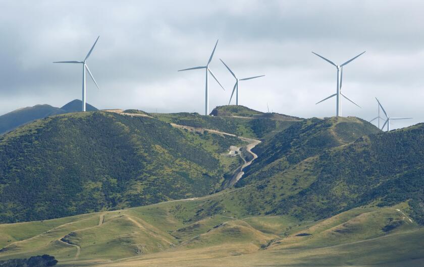Wind power turbines on green hill near Wellington, New Zealand