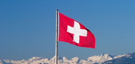 Swiss flag and Alps