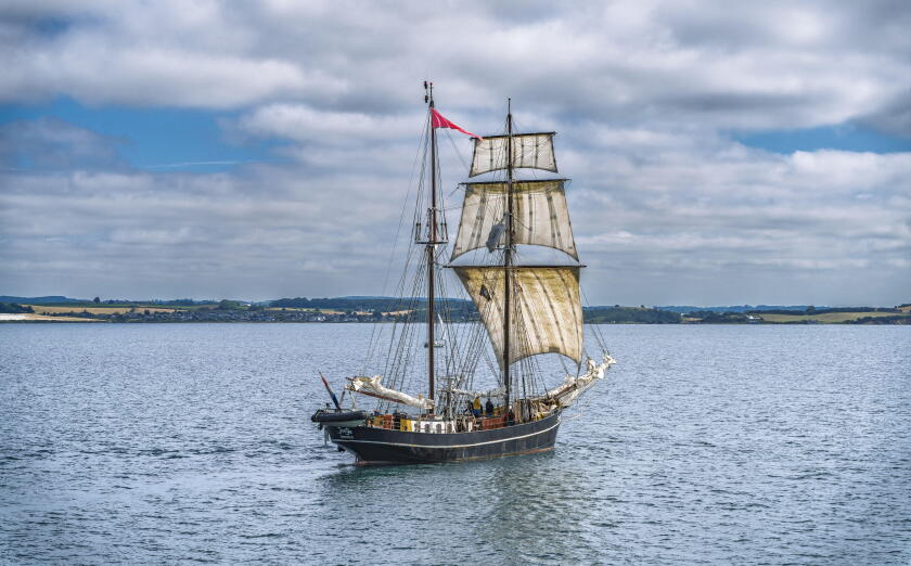 Classic maritime vessel in serene seascape.