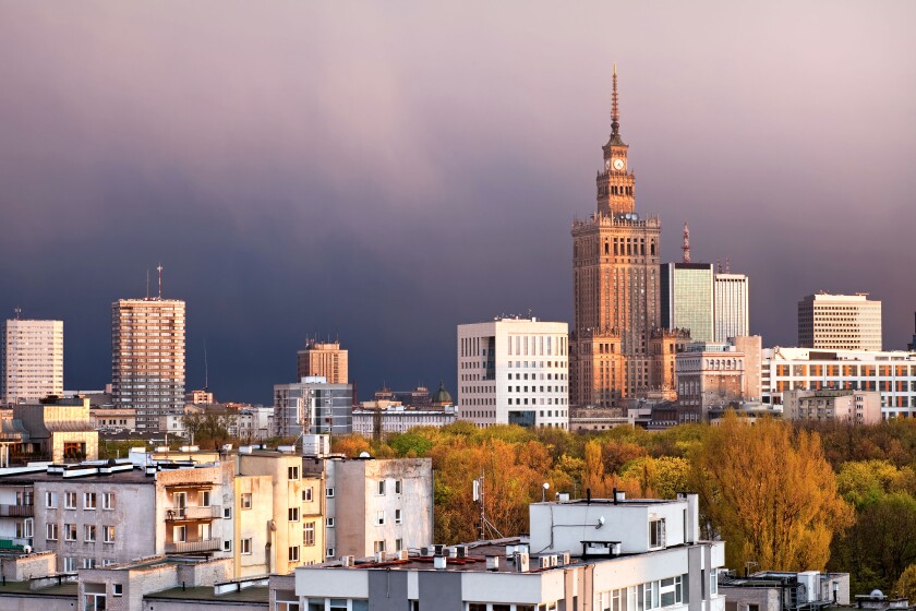 Warsaw, capital city of Poland, featuring Palace of Culture and Science, Srodmiescie district. Sunset time, stormy sky.
