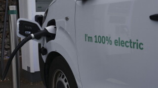 An electric van charges at a Moto service station on the M5 motorway, Exeter, UK