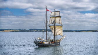 Classic maritime vessel in serene seascape.