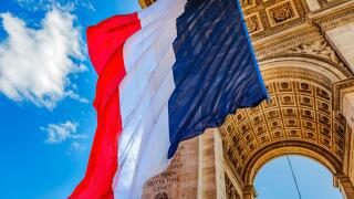 Arc de Triomphe and French flag, Paris, France. Completed in 1836 monument to the dead in the French Revolution and Napoleonic Wars. Includes Tomb to