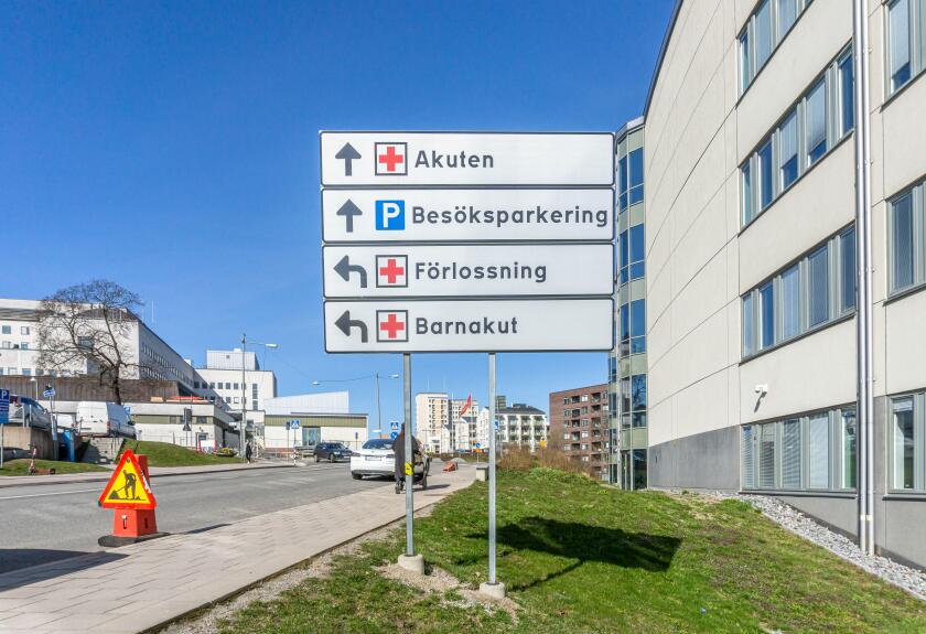 Stockholm, Sweden - April 15, 2021: Traffic signs with directions explained at the entrance to hospital area